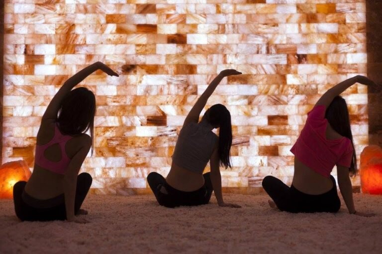 Group yoga class practicing in the Himalayan salt room at Salt Spa Haven in Fayetteville, Georgia.
