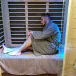 Guest relaxing in an infrared sauna session at Salt Spa Haven in Fayetteville, Georgia.